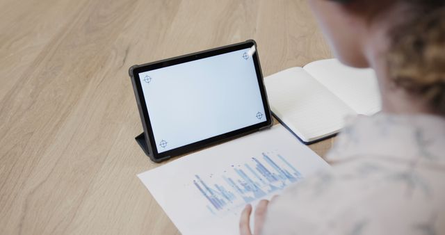 Businessperson Analyzing Data on Tablet and Paper Chart - Download Free Stock Images Pikwizard.com