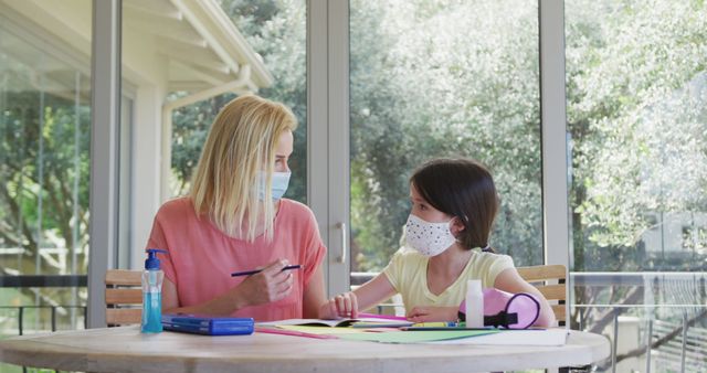 Mother and Daughter Wearing Masks Home Schooling Together - Download Free Stock Images Pikwizard.com