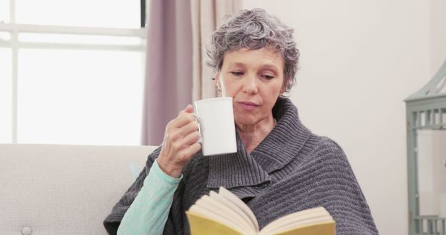 Senior Woman Relaxing with Coffee and Book at Home - Download Free Stock Images Pikwizard.com