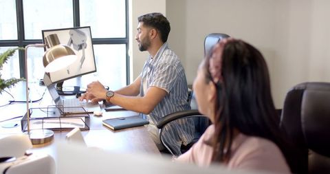 Professional teamwork: coworkers collaborating at modern office