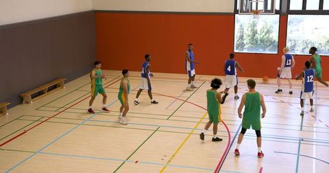 Intense Basketball Game in Indoor Sports Hall with Diverse Athlete Teams