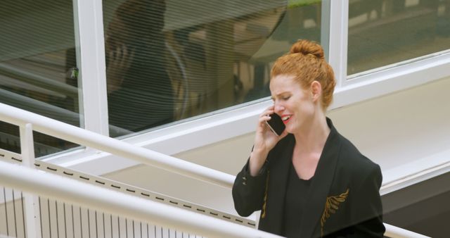 Businesswoman walking while taking phone call - Download Free Stock Images Pikwizard.com