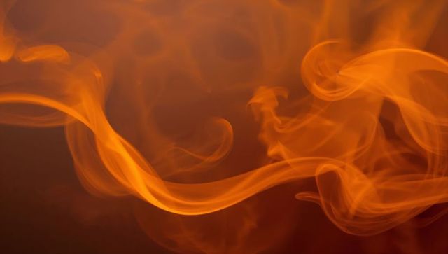 Swirling Orange Smoke Against Reddish-Brown Backdrop