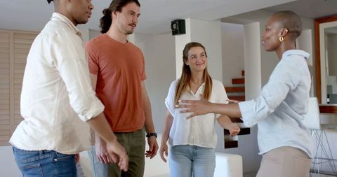 Diverse friends brainstorming together indoors