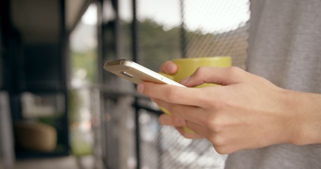 Close-Up of Hands Using Smartphone with Coffee Cup on Balcony - Download Free Stock Images Pikwizard.com