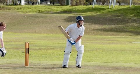 Cricketer Performs Battling Technique on Sunny Sports Field