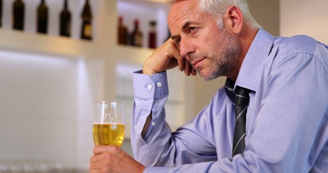 Contemplative Businessman Sipping Beer in Bar After Work - Download Free Stock Images Pikwizard.com