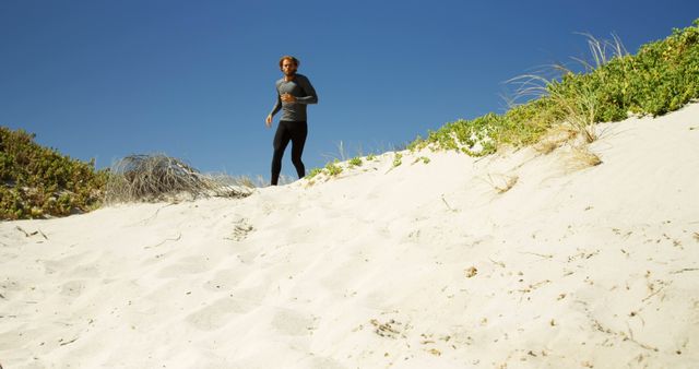 Athletic Man Jogging on Sandy Beach Dunes Under Clear Blue Sky - Download Free Stock Images Pikwizard.com