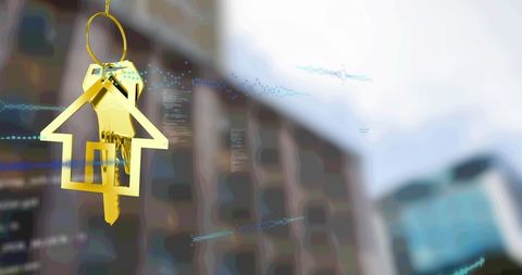 Golden house key overlaying modern cityscape for real estate concepts