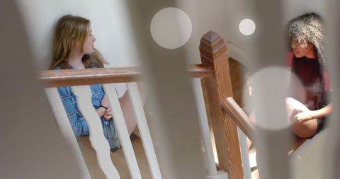 Two Teenage Girls Talking on Stairs in Sunlit Home Interior - Download Free Stock Images Pikwizard.com