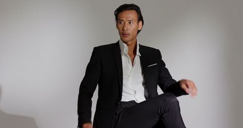 Business Professional Seated in Black Suit with Monochrome Background