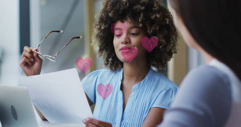Digital Interface Animation with Heart Icons Overlay on Diverse Businesswoman