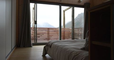 Minimalist Bedroom with Scenic Mountain Balcony View
