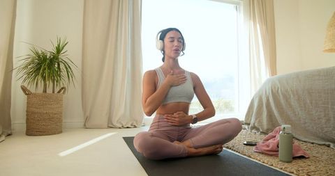 Tranquil meditation at home in softly lit bedroom environment