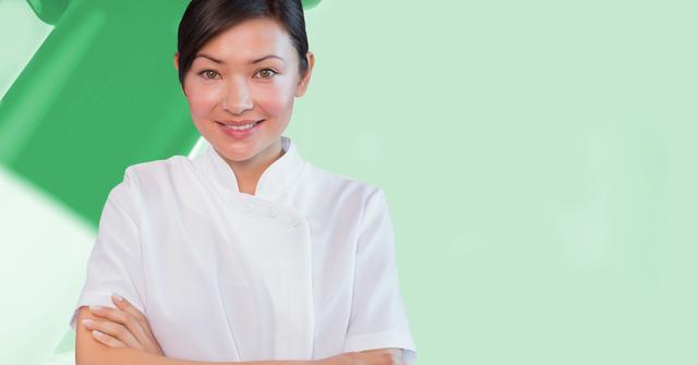 A female therapist in a white coat stands with her arms crossed against a minimalist green background. Ideal for use in healthcare marketing materials, wellness websites, medical professional profiles, or any campaign highlighting trust and professionalism in healthcare services.