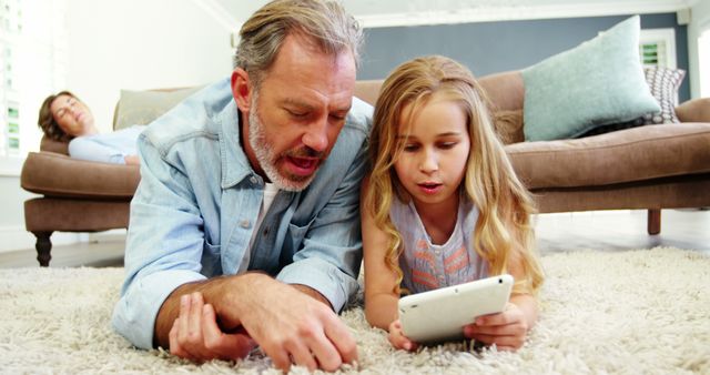 Father and Daughter Enjoying Leisure Time with Tablet on Floor - Download Free Stock Images Pikwizard.com