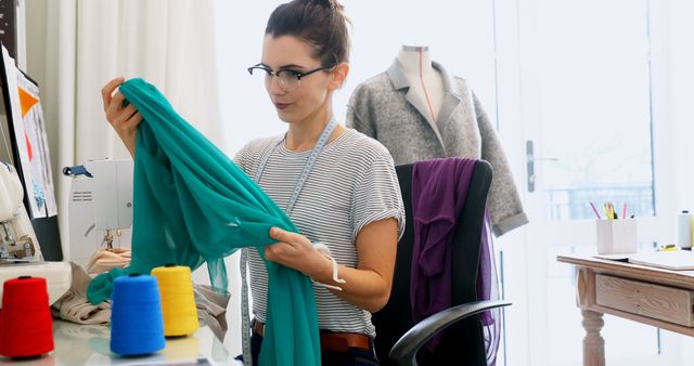 Young Fashion Designer Examining Fabric Material in Creative Studio - Download Free Stock Images Pikwizard.com