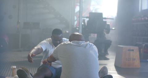 African American Men Partner Stretching on Gym Floor for Mobility and Strength Training