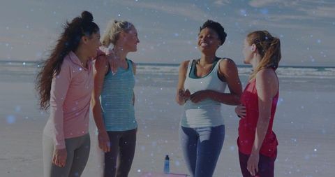 Women practicing beach fitness together during sunrise group workout and friendship session