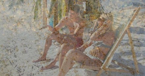 Couple Relaxing on Tropical Beach Under Sunshelter