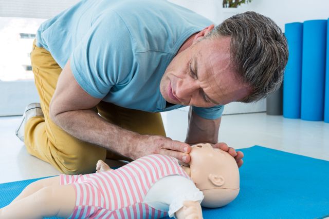 Paramedic Practising Infant CPR on Training Dummy - Download Free Stock Photos Pikwizard.com