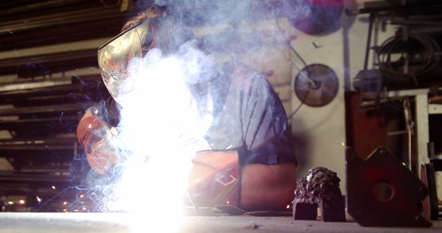 Industrial Welder Working with Sparks and Smoke in Workshop - Download Free Stock Images Pikwizard.com