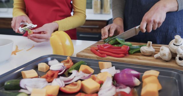 Happy caucasian lesbian couple preparing food in sunny kitchen - Download Free Stock Photos Pikwizard.com