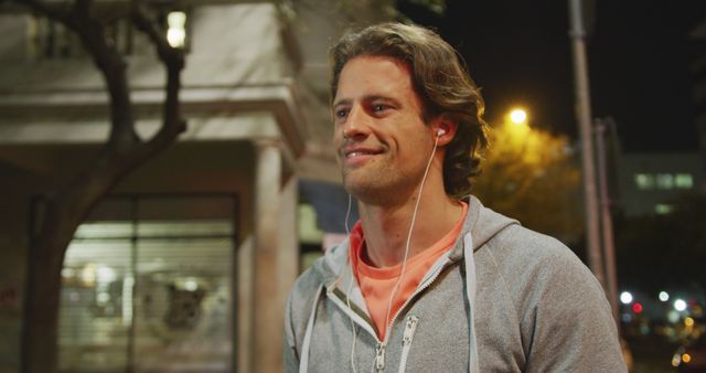 Man jogging with headphones at night, city street - Download Free Stock Images Pikwizard.com