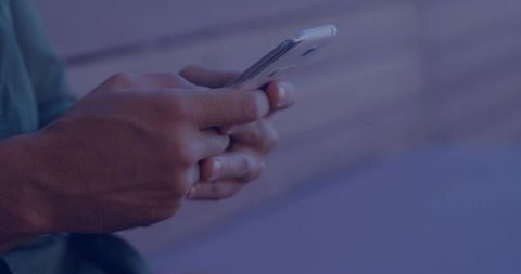 Mid-adult Hands Tapping Smartphone on Wooden Bench Showing Ring and Green Shirt Moody