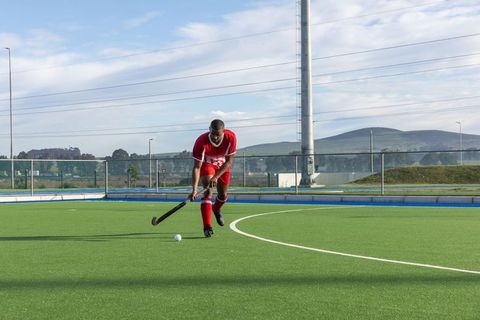 Field hockey player in action on sunny day