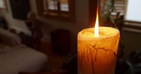 Cozy Candlelit Home Ambiance with Siblings in Background - Download Free Stock Images Pikwizard.com