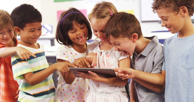 Group of diverse children gathered around tablet, learning enthusiastically in classroom. Useful for educational, technology in education, and diverse learning environments content.