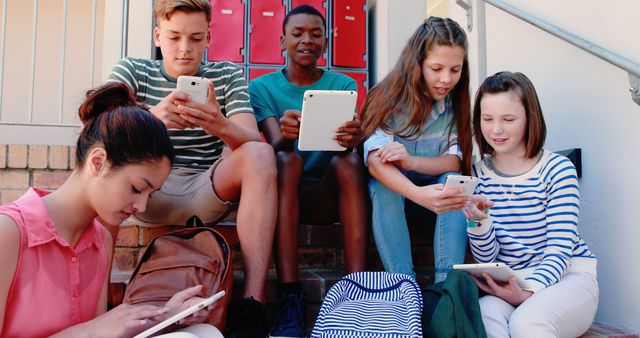 Diverse group of students using tablets and smartphones - Download Free Stock Images Pikwizard.com