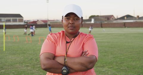 African american rugby trainer in determined pose on field