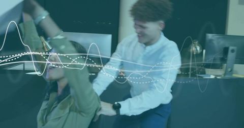 Colleagues sharing playful moment laughing and celebrating teamwork at modern reception