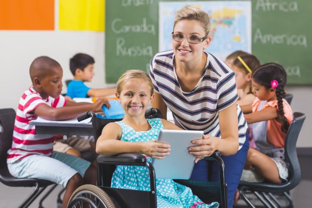 Smiling schoolgirl and teacher using digital tablet in classroom at school