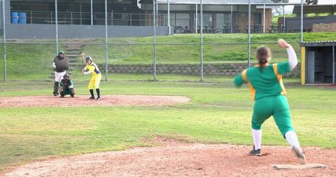 Female softball player pitching in game competition