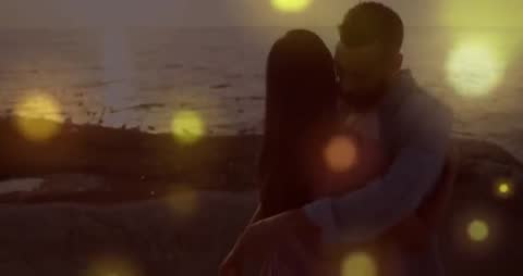 Romantic Embrace of Couple by Ocean with Glowing Light Effects