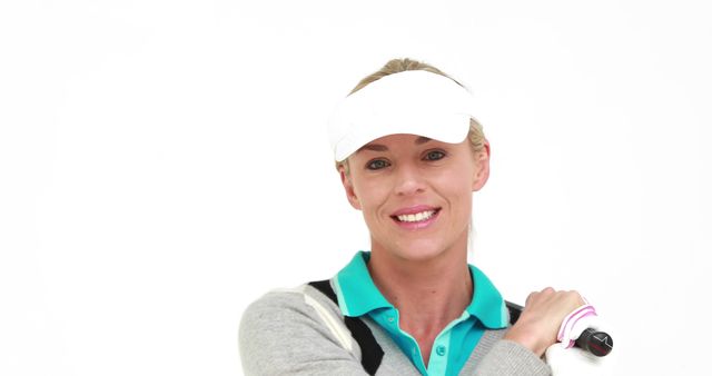 A Caucasian woman, a golfer, is smiling at the camera, holding golf clubs, with copy space - Download Free Stock Photos Pikwizard.com
