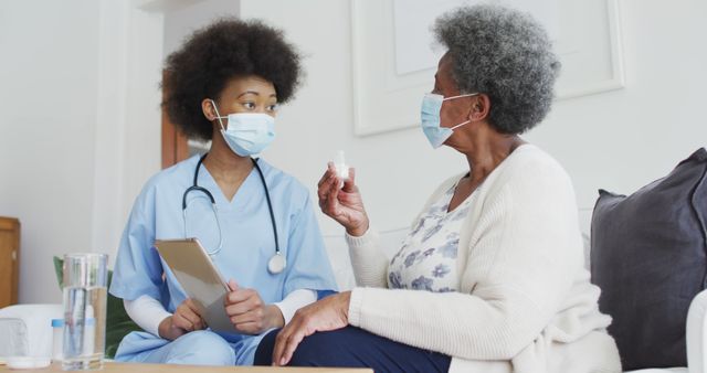 Healthcare Professional Assisting Senior Woman with Medication at Home - Download Free Stock Images Pikwizard.com