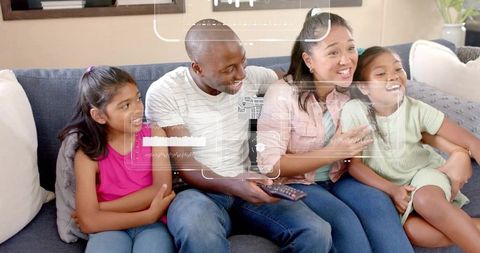 Family watching tv together on sofa with smart hud overlay showing media data