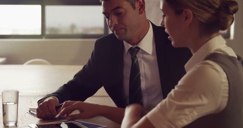 Business partners analyzing documents in meeting