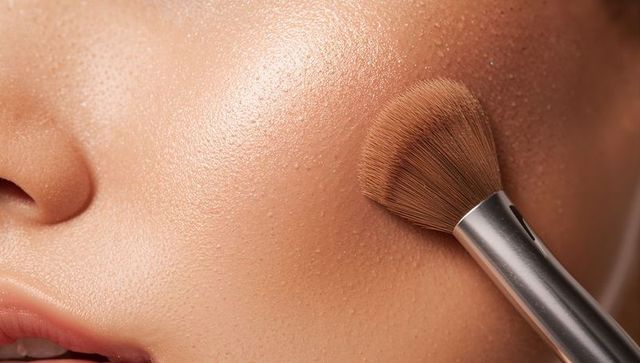 Applying Makeup with Brush for Seamless Accomplished Beauty Close-up
