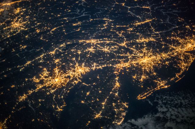 Northeastern United States captured at night from space, showcasing illuminated urban areas. Useful for topics related to astronomy, geology, environmental studies, urban planning, and showcasing the beauty of our planet from space.