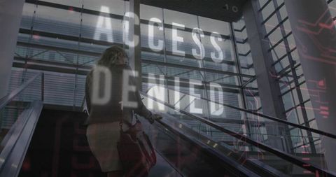 Businesswoman ascending escalator with access denied cybersecurity overlay in glass atrium