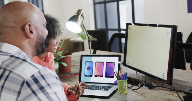 UI/UX Designers Collaborating on Mobile App Project in Modern Office - Download Free Stock Images Pikwizard.com