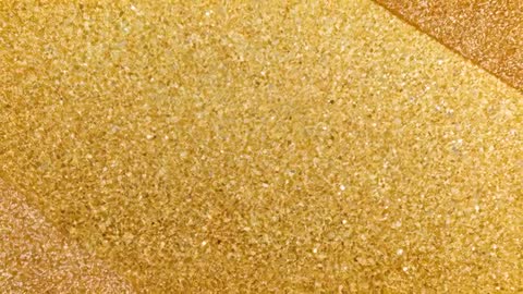 Glittering Gold Grain Macro Texture Revealing Diagonal Metallic Stripes During Camera Sweep