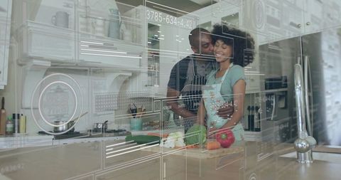 Black couple embracing while preparing vegetables with AR kitchen HUD romantic homecooking