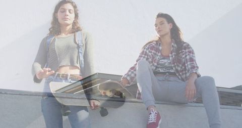 Double Exposure of Young Women Relaxing with Skateboards