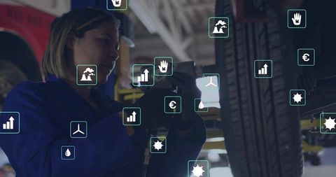 Mechanic Using Impact Wrench with Floating Data Icons in Auto Workshop
